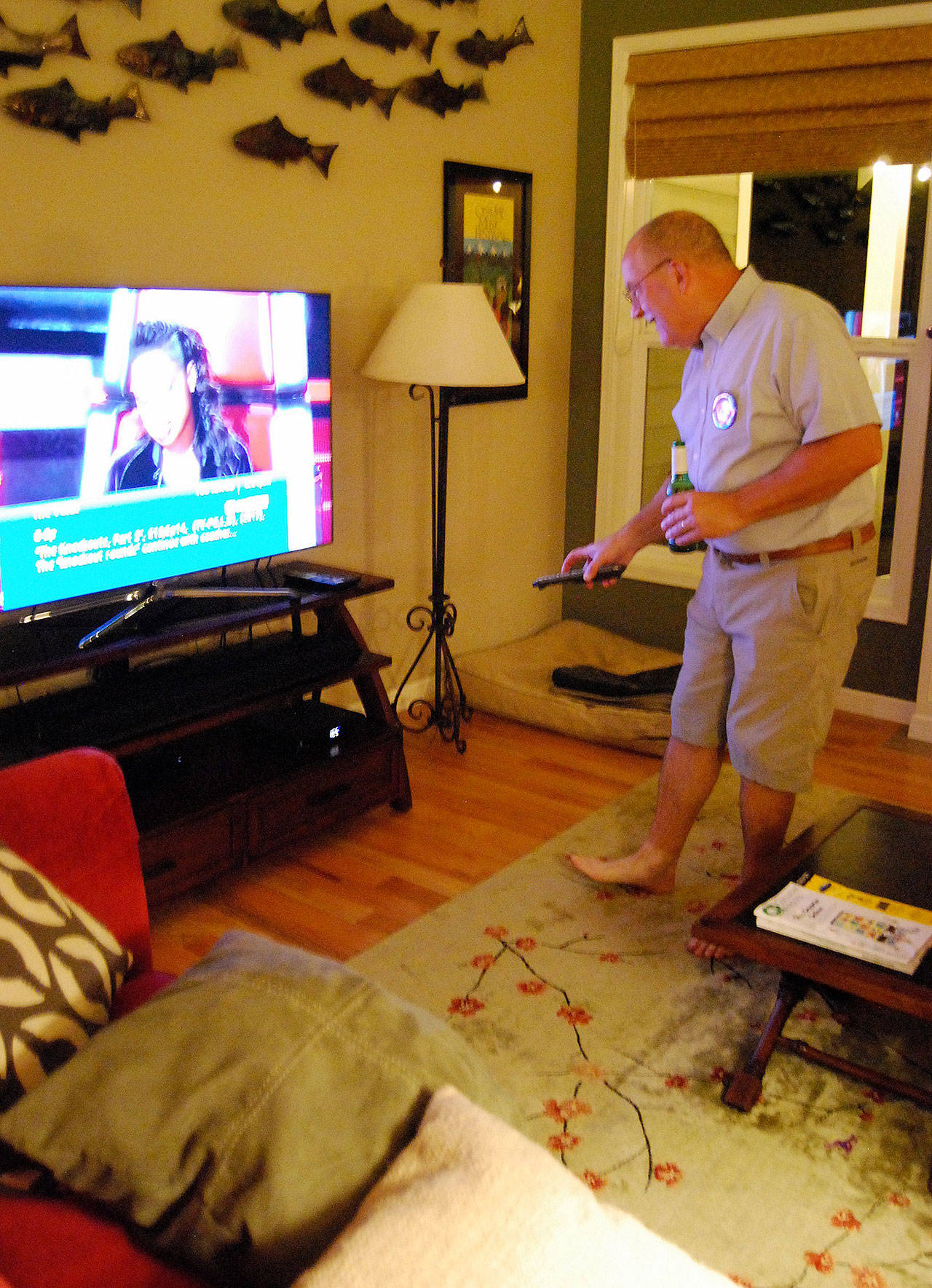 Candidate Jay Rosapepe, who a little later heard the news of his election win for the at-large seat on the Port Orchard City Council, checks the television in his McCormick Woods home for initial local election returns.                                Bob Smith | Independent