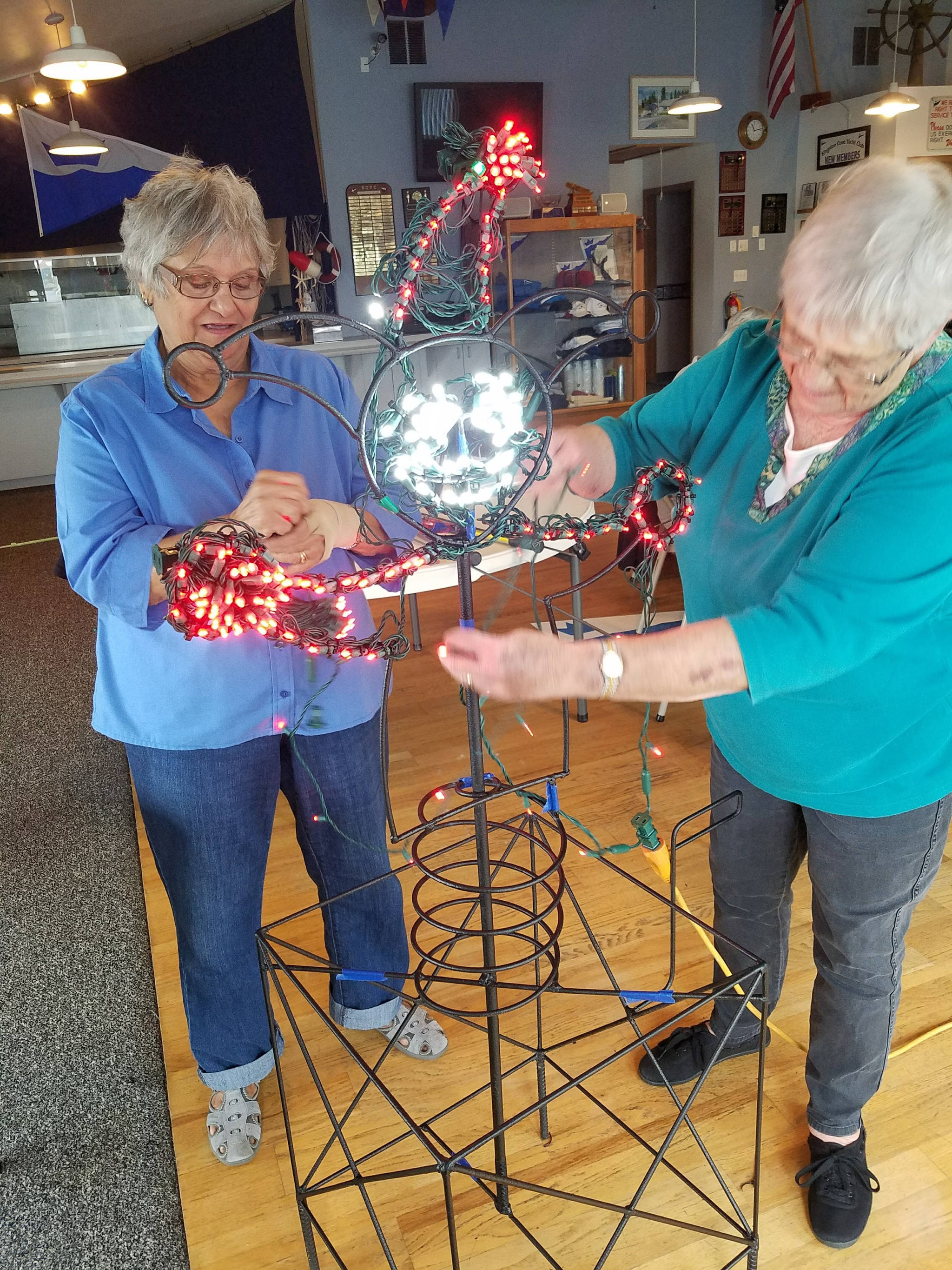 Volunteers stirng lights for the annual festivities.