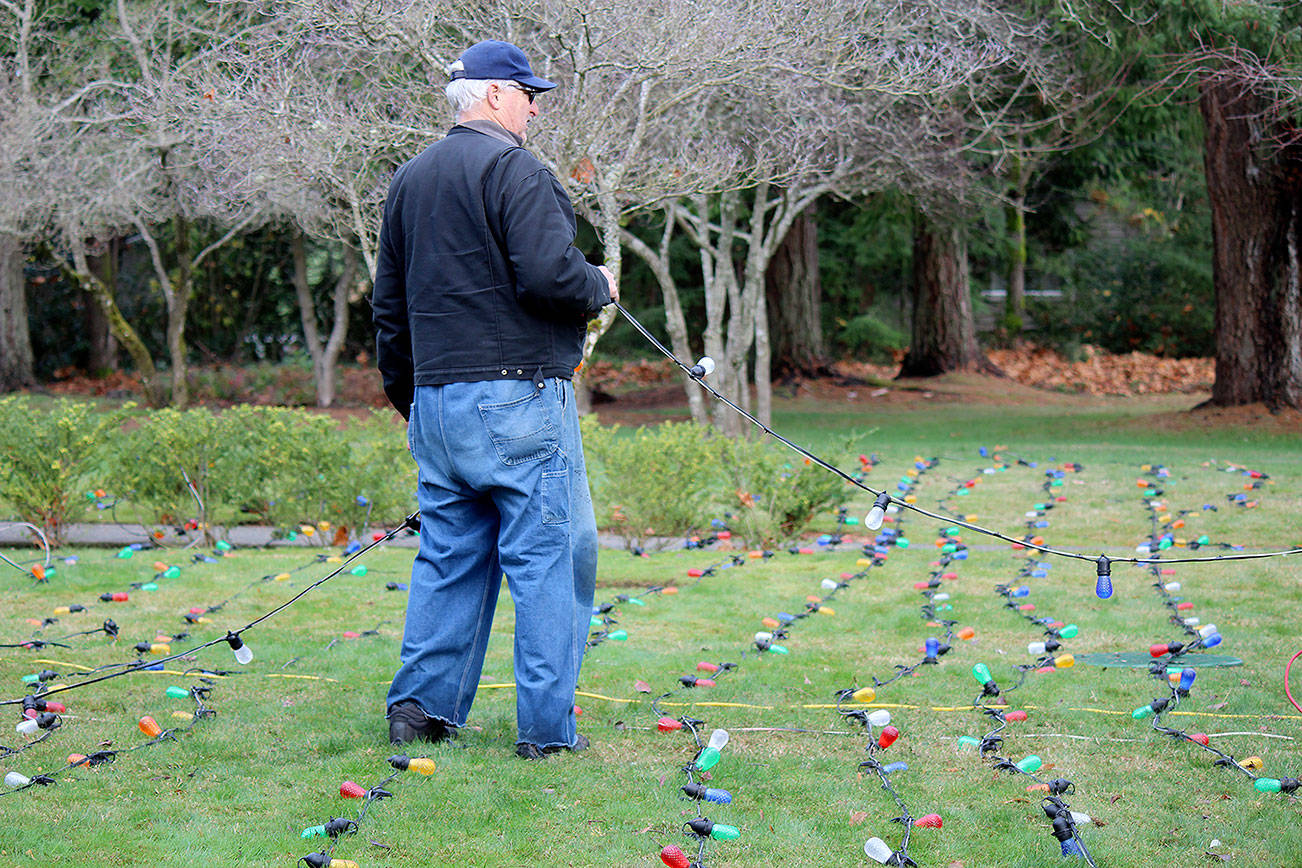 Bob Carter repaired the 600 lights that decorate the Tracyton Community Tree.                                Michelle Beahm / Kitsap News Group