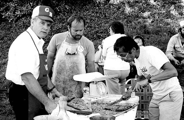 Longtime Friends of Manchester Library volunteer Nobi Kawasaki (slicing salmon) helped out at a salmon bake fundraiser in the 1970s. (Photo: Manchester Library photo)