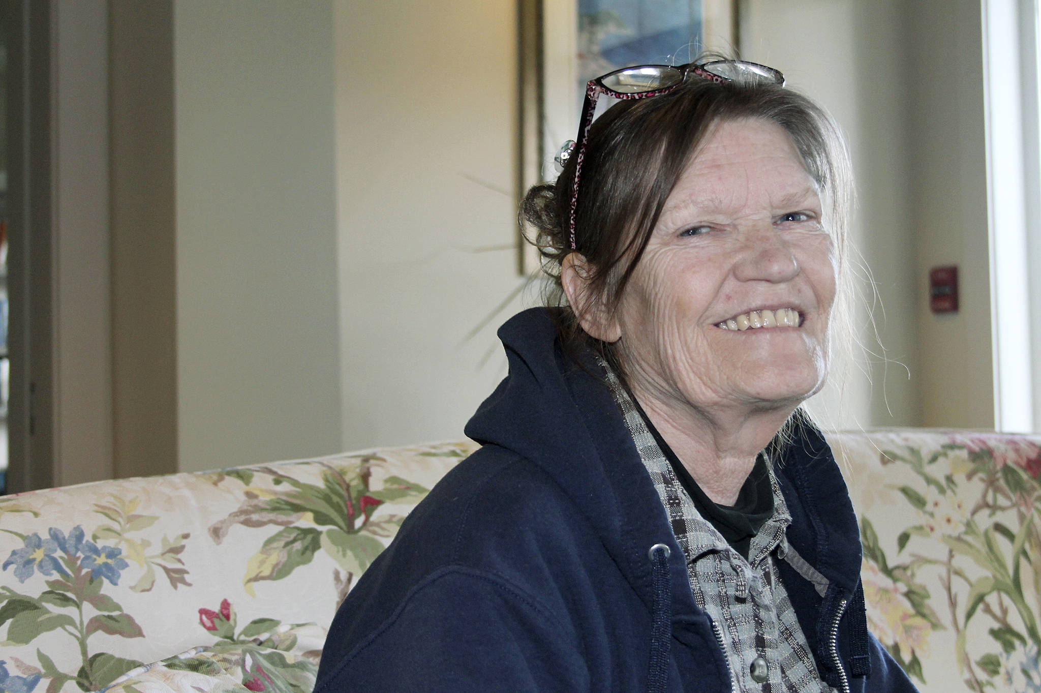 Victoria Detrick takes a break from unpacking her belongings at her new apartment she was able to secure with the help of North Kitsap Fishline.                                Leslie Kelly/Kitsap News Group