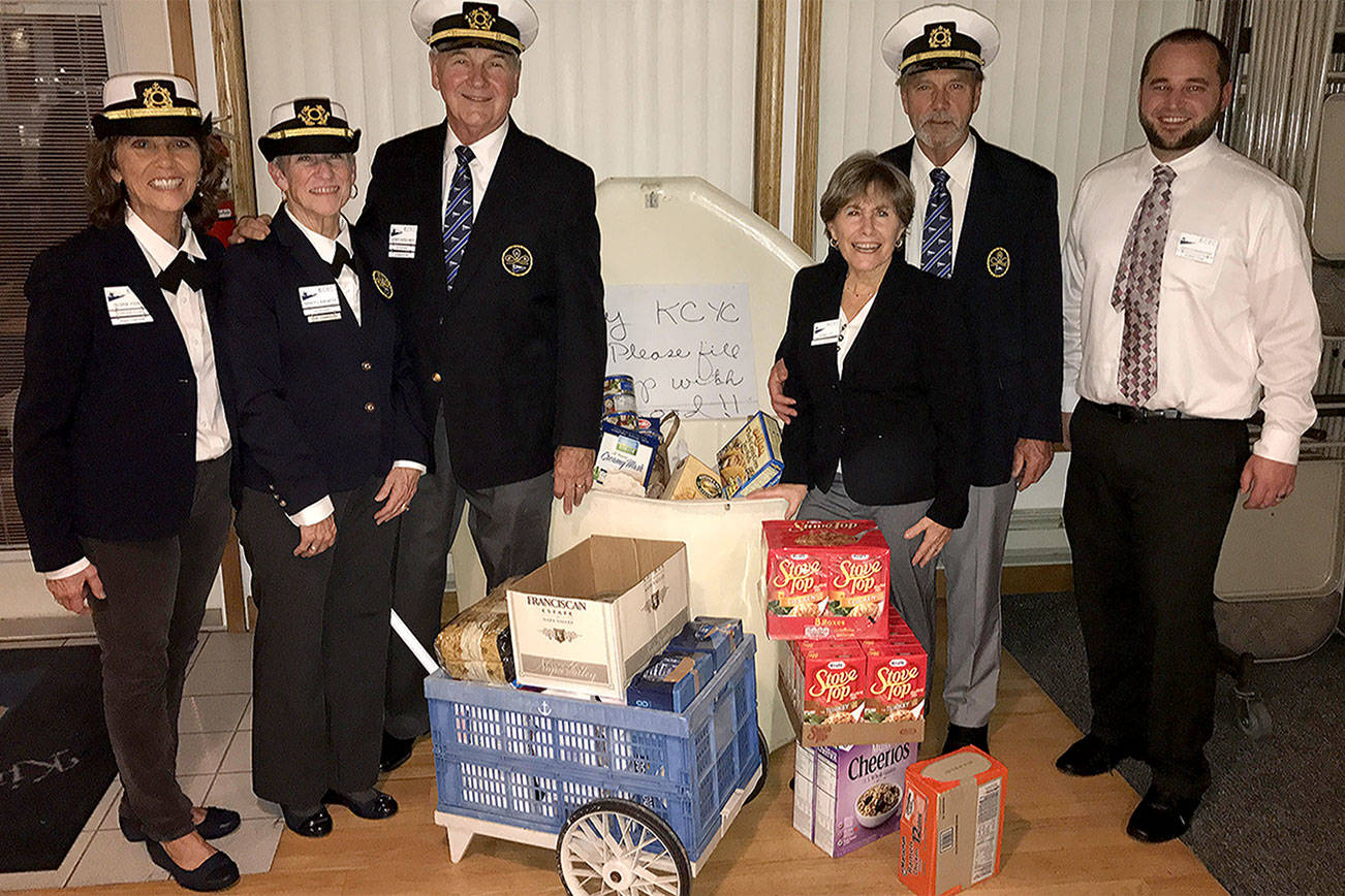 After cooking Thanksgiving dinner for Kingston Cove Yacht Club members, club officers pause to celebrate the dock box full of food headed to the Kingston Food Bank. From left, Gloria Young, fleet captain; Nancy Langwith, vice commodore; Jerry Kirschner, commodore; Robin Lott, secretary; Jack Lott, rear commodore; and Zach Cunningham, treasurer. Contributed photo