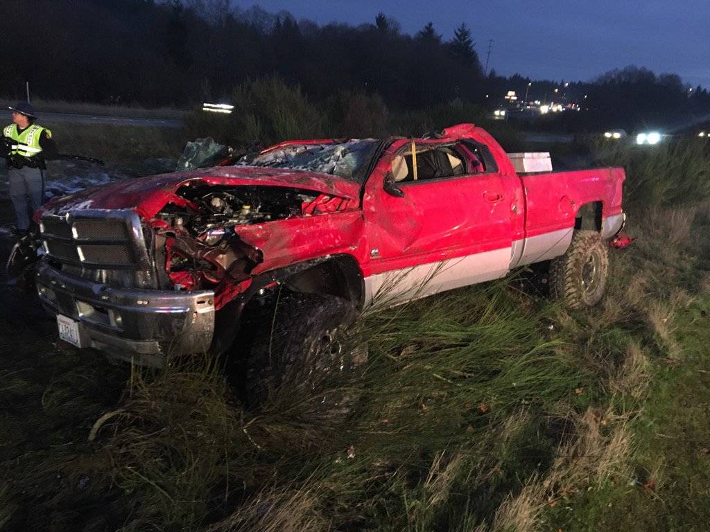 A truck hauling a trailer with an excavator aboard overturned in the eastbound lanes of SR 16 at SR 160 Monday afternoon Dec. 4. Washington State Patrol Trooper Russ Winger said the trailer and excavator had been stolen. (Photo: Washington State Patrol)