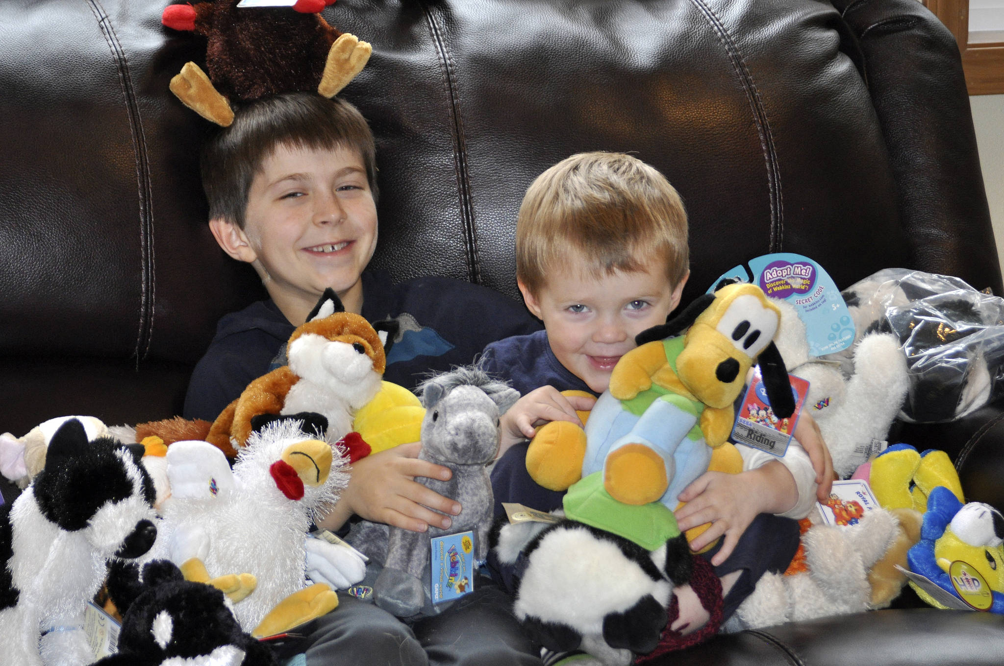 From left, Zachary Darner and Noah Darner sit among some of the early toys collected for Kidzz Helping Kidzz 2017. As of Dec. 5, Zachary collected more than 500 toys, and hopes to collect 500 more before time is up Dec. 18.                                Michelle Beahm / Kitsap News Group