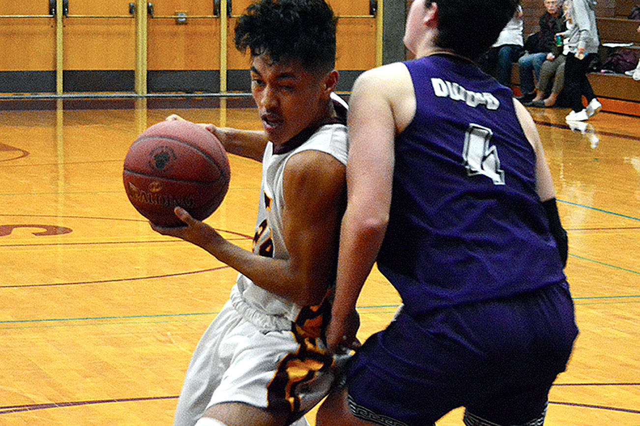 South Kitsap point guard Riley Escolta tries to muscle past Sumner’s Mitchell Wolfe (4) during the 58-54 loss to the Spartans on Dec. 7. Escolta scored 13 points in the game for the Wolves. (Mark Krulish/Kitsap Daily News)