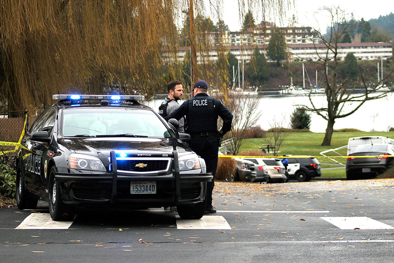 Bremerton police officers consult near the scene of an officer-involved shooting Dec. 17. (Nick Twietmeyer/Kitap News Group)