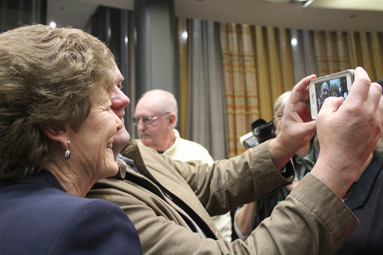 Patty Lent takes a photo with a Bremerton resident at her farewell party Dec. 28.                                Michelle Beahm / Kitsap News Group