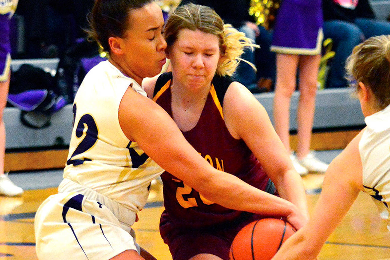 &lt;em&gt;Kingston’s Sierra Denning (20) tries to muscle past Olivia Selembo and Katie Hughes (24) of North Kitsap on Jan. 9. The Vikings won the game 50-40.  &lt;/em&gt;Mark Krulish/Kitsap News Group