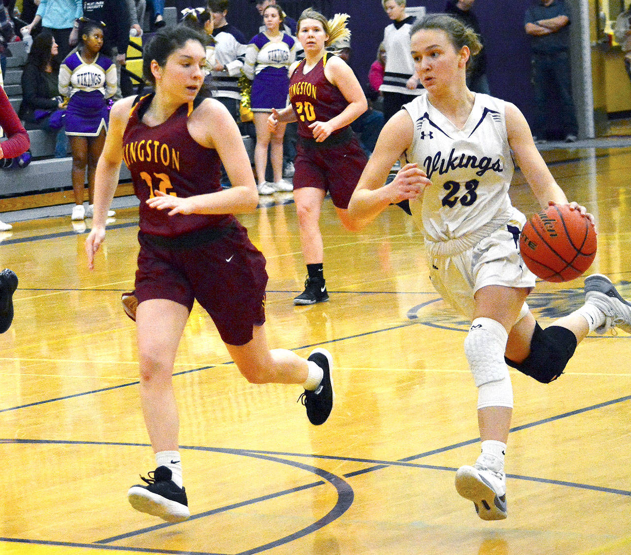 Raelee Moore (23) of North Kitsap on the fast break as Kingston’s Lily Beaulieu (12) attempts to stop her. (Mark Krulish/Kitsap News Group)