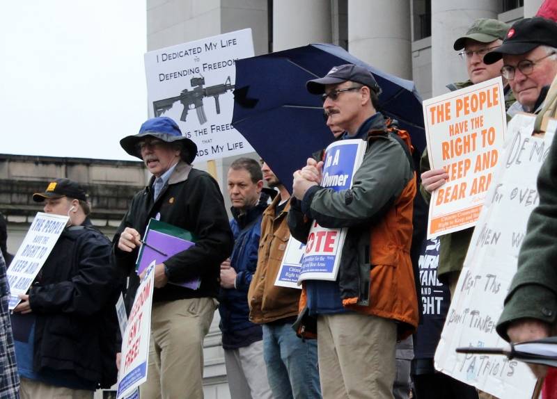 Gun rights supporters gather on the steps of the Capitol building for a rally Jan. 12.                                Taylor McAvoy of the WNPA Olympia News Bureau