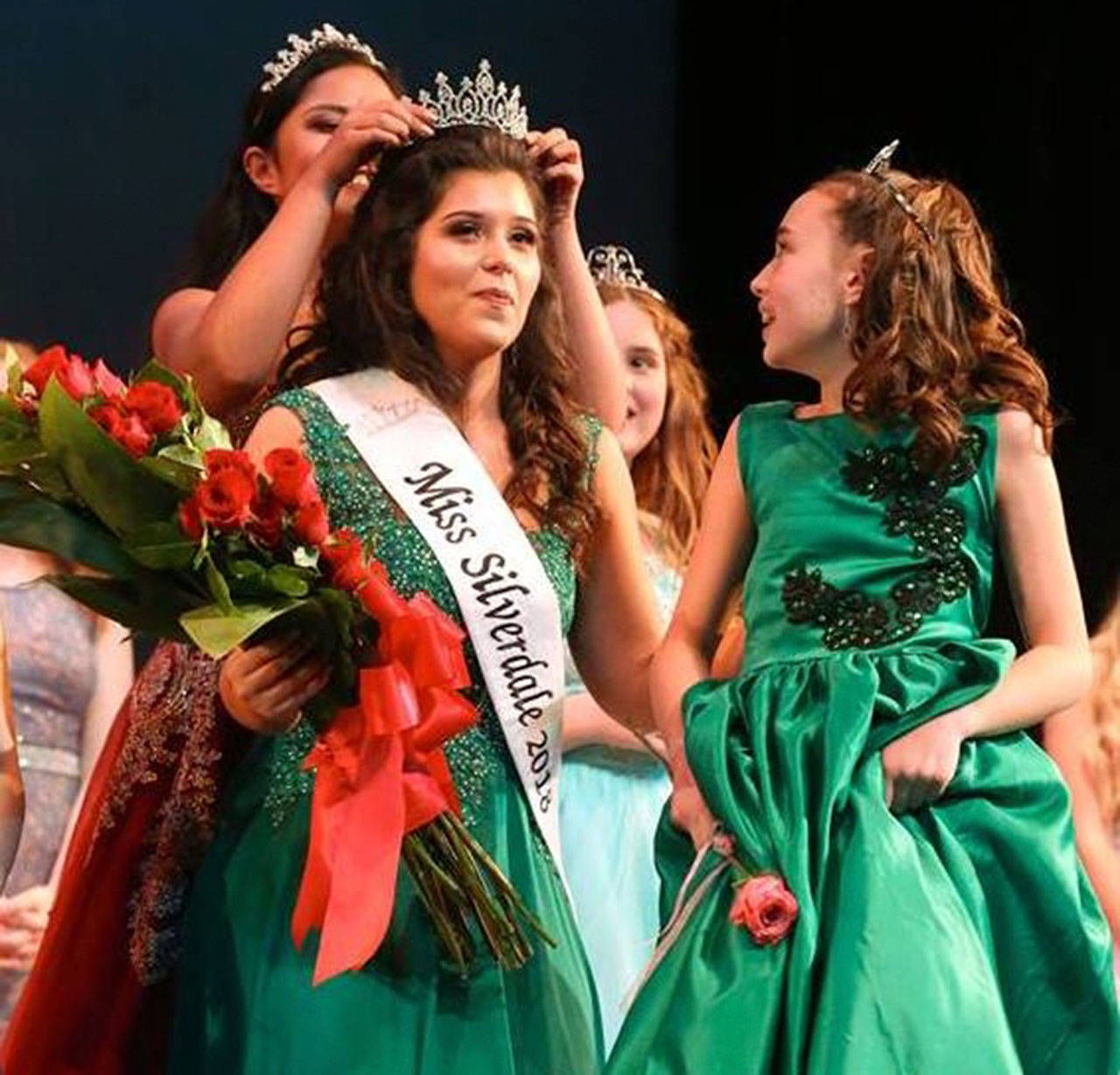 Miss Silverdale 2017 Colby Conde crowns Emily Rider while her pageant Little Sister Mia Coombe looks on.                                Jesse Beals/Olympic Photo Group