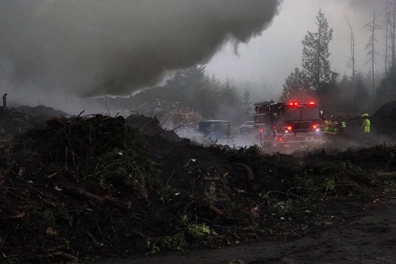 North Kitsap Fire & Rescue firefighters had contained a stump pile fire near Hansville around noon, but reported that the fire was “stubborn,” so firefighters would likely be on scene throughout the day.                                NKF&R/Courtesy