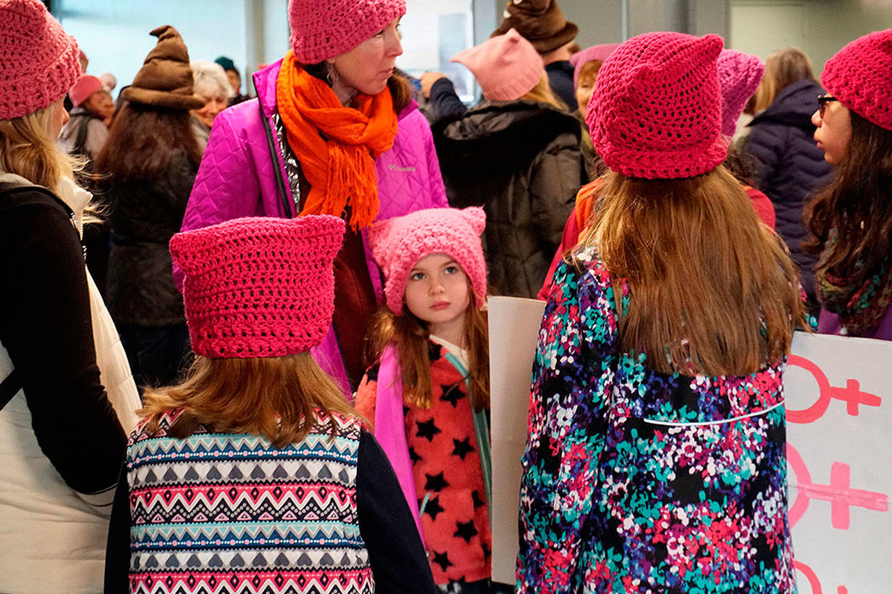 Marchers from Bainbridge and the Kitsap Peninsula, many of them wearing pink hats and carrying signs, walked through Winslow toward the ferry terminal Jan. 20 to set sail for Seattle and join the ranks of the second Women’s March. (Luciano Marano/Kitsap News Group)