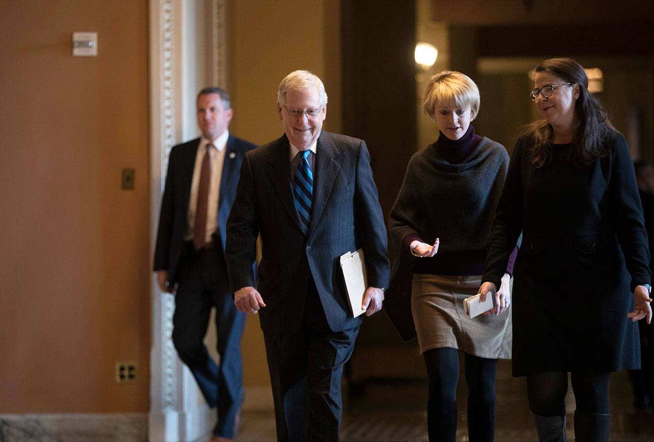 Senate Majority Leader Mitch McConnell, R-Ky., returns to chamber as the federal shutdown enters its second day amid a partisan blame game on both sides, at the Capitol in Washington, D.C., on Sunday. (J. Scott Applewhite/The Associated Press)