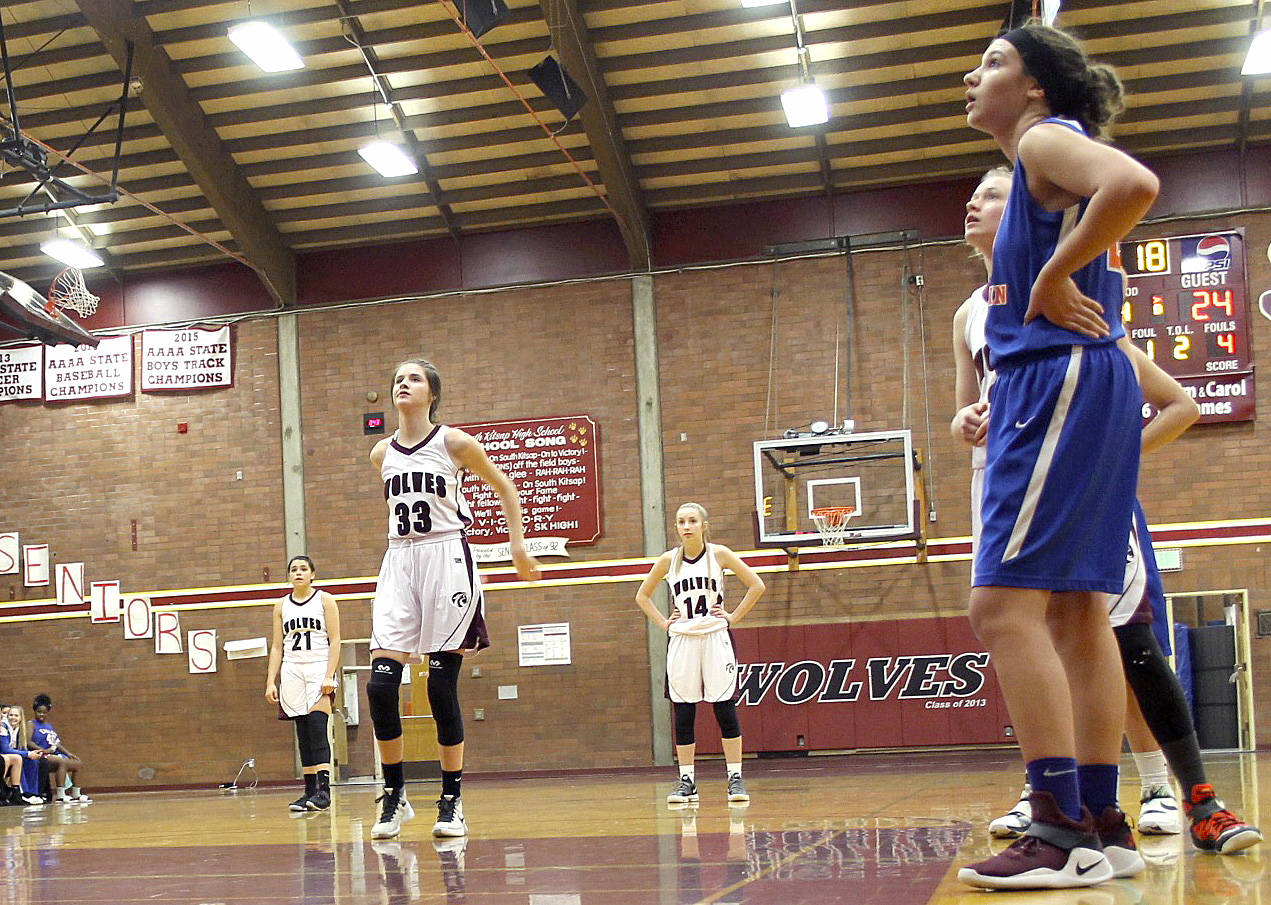 Jennie Goldsberry of Graham-Kapowsin, right, watches Kaylee McEdward of South Kitsap shoot from the free throw line. (Jacob Moore/Kitsap News Group)