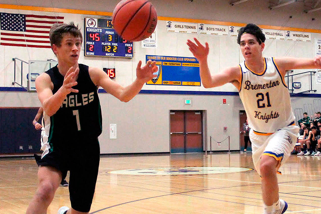 Klahowya’s Jacob Kraft (1) and Bremerton’s Gavin King (21) scramble for a loose ball. The Knights won their first game of the season on Jan. 26, defeating the Eagles 58-43. (Jacob Moore/Kitsap News Group)