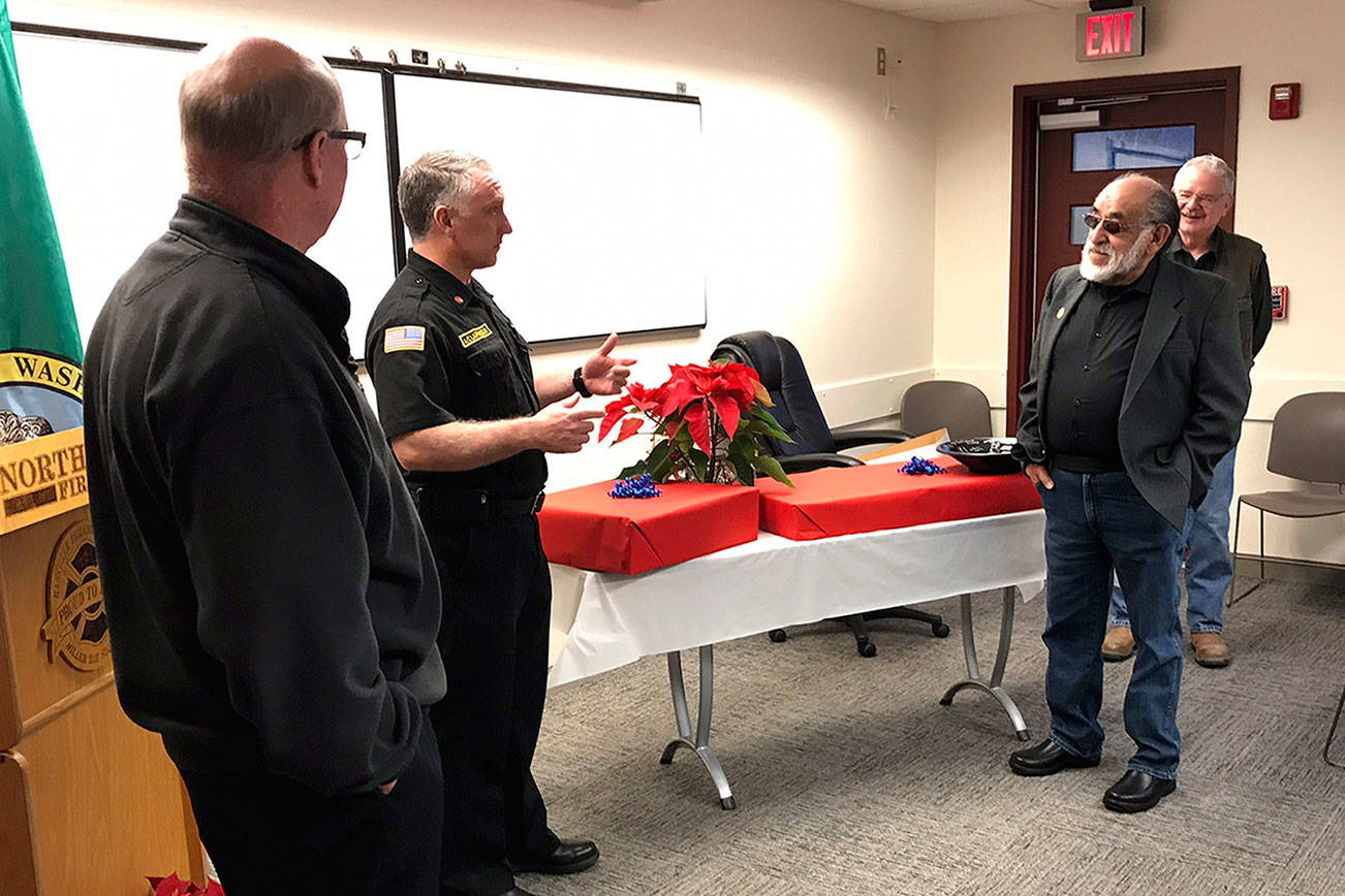 &lt;em&gt;At a well-attended reception in early January, retiring NKF&R Fire Commissioner Fernando “Espy” Espinosa, second from right, was honored with gifts presented by, from left, NKF&R Fire Chief Dan Smith, NKF&R Assistant Chief Rick LaGrandeur, and fellow commissioner Stephen Neupert.  &lt;/em&gt;NKF&R photo