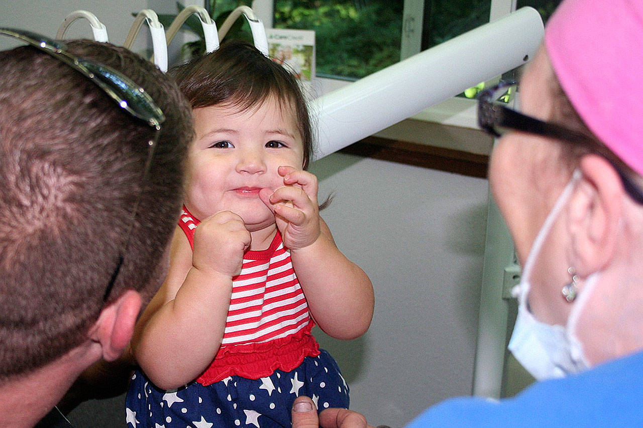 Annika Creed, 1, gets her first dental checkup at last year’s clinic. Her father, Jeremy Creed, is a Navy Reservist. Creek and his wife, Amy Creed, are owners of Amy’s On The Bay and Sidelines in Port Orchard. They came out to support veterans in the South Kitsap community. (Courtesy photo)
