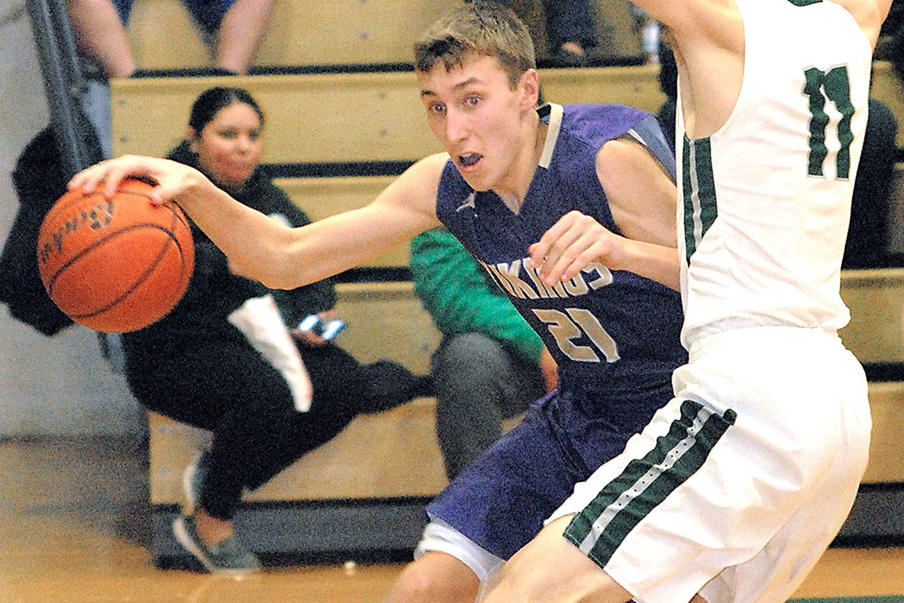 North Kitsap’s Logan Chmielewski evades the defense of Port Angeles’ Colton McGuffey during the third quarter on Tuesday night at Port Angeles High School. (Keith Thorpe/Peninsula Daily News)