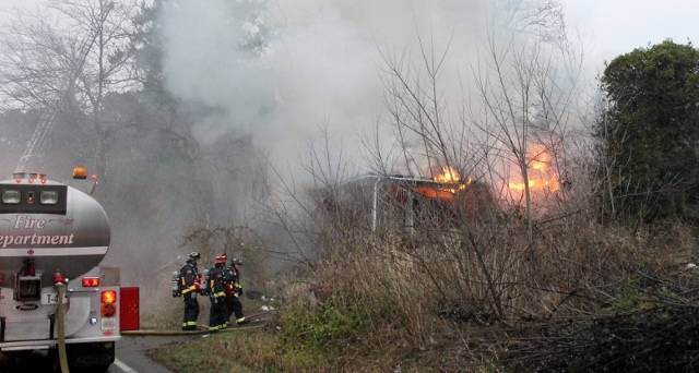 Bremerton city firefighters were working at 5 p.m. Feb. 3 to contain a house fire on Tracyton Beach Road. (Jacob Moore/Kitsap News Group)