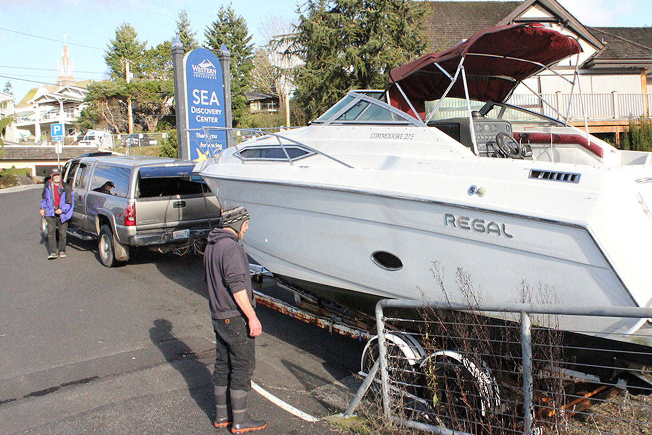 Volunteers hoist sunken boat out of Liberty Bay