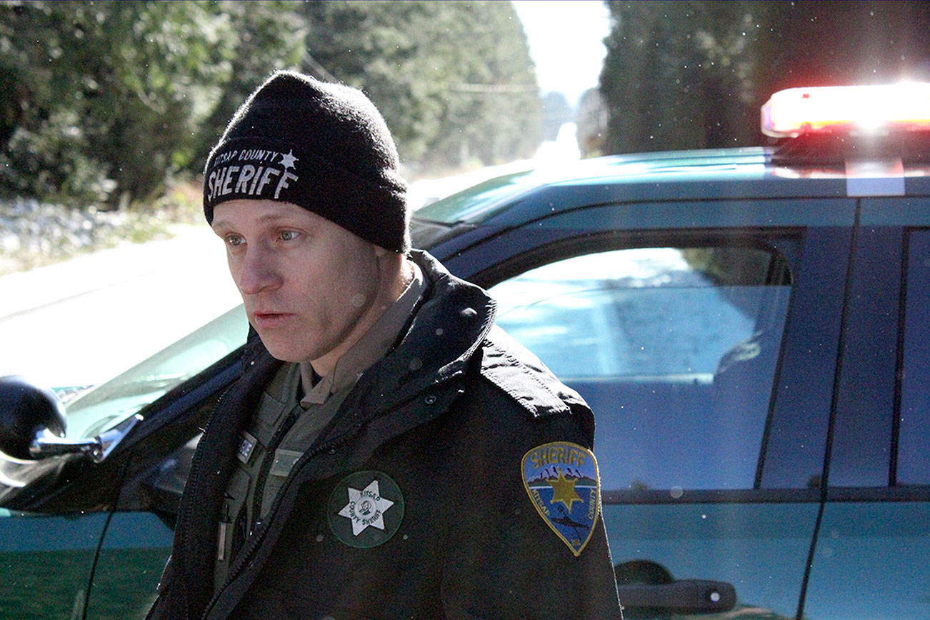 Kitsap County Sheriff’s Deputy Schon Montague estimates there are about 150 homes in the secured area. He was controlling traffic at Clear Creek Road and Closser Drive. (Nick Twietmeyer/Kitsap News Group)