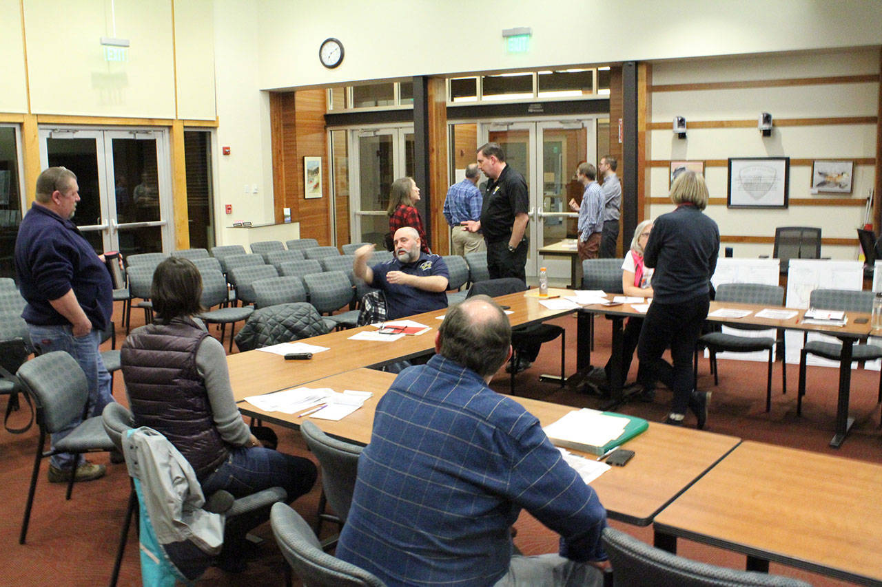 Members of Poulsbo’s Street and Pedestrian Safety Enhancement Plan’s advisory committee talk amongst themselves during a brief break. Nick Twietmeyer | Kitsap Daily News