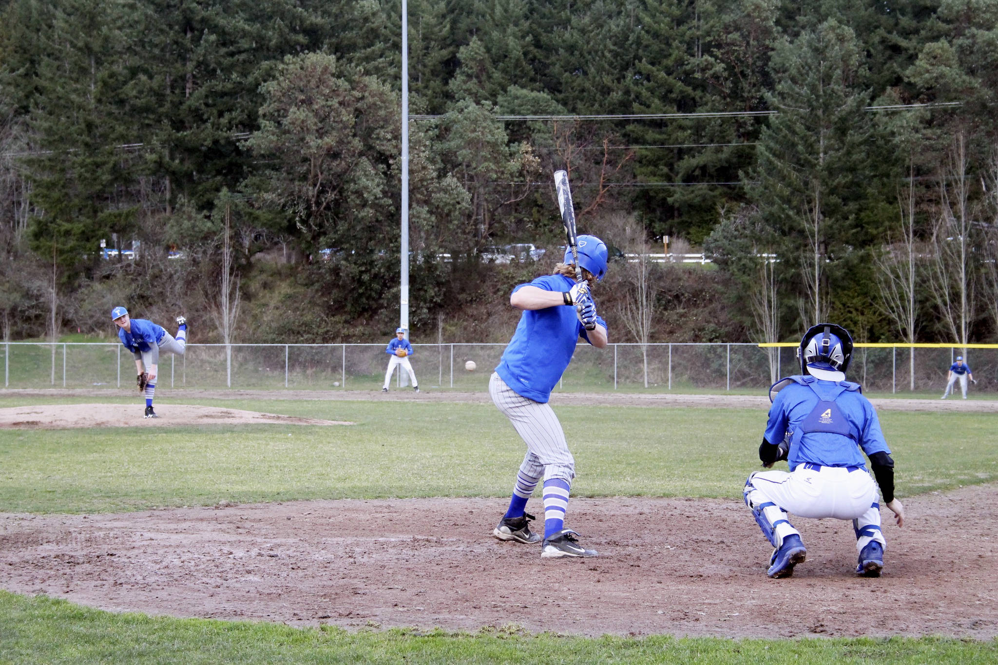 Senior right-hander Evan Turnquist eyes a pitch before fouling it off during a March 9 practice at Olympic High School. Jacob Moore | Kitsap News Group