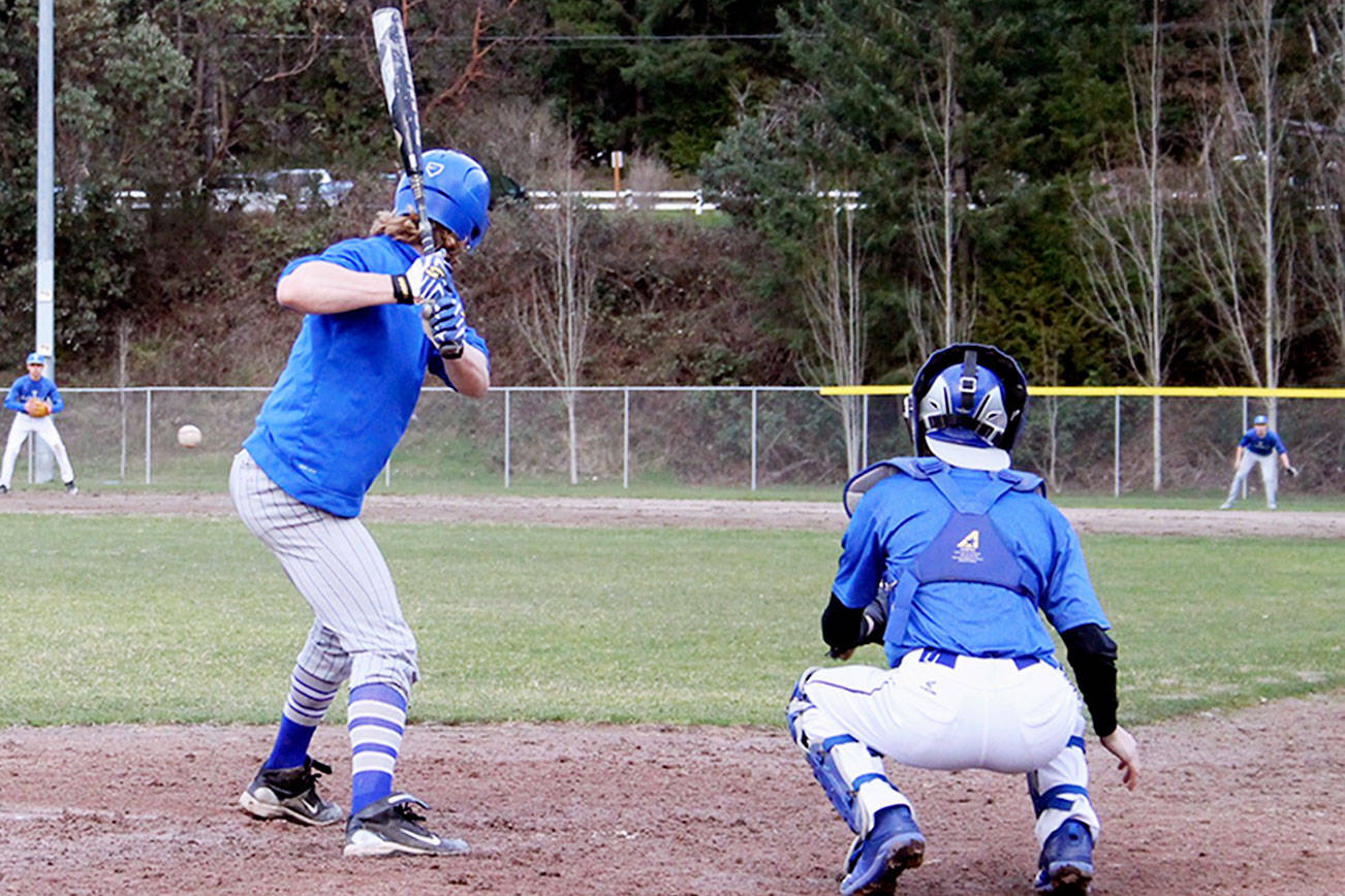 Senior right-hander Evan Turnquist eyes a pitch before fouling it off during a March 9 practice at Olympic High School. Jacob Moore | Kitsap News Group