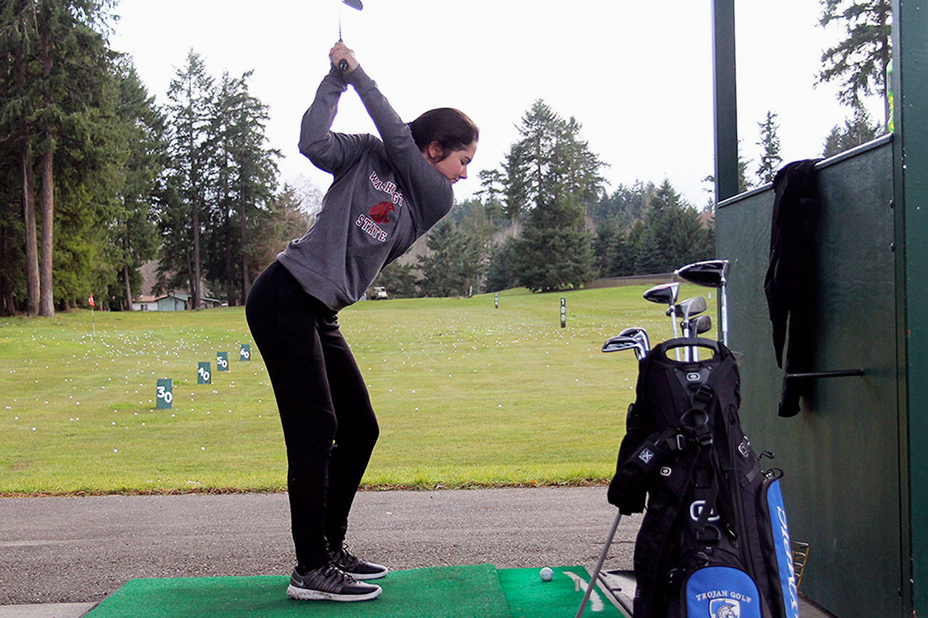 Junior golfer Zoie Matheny tees off during a March 9 practice at Rolling Hills Golf Course. Jacob Moore | Kitsap News Group