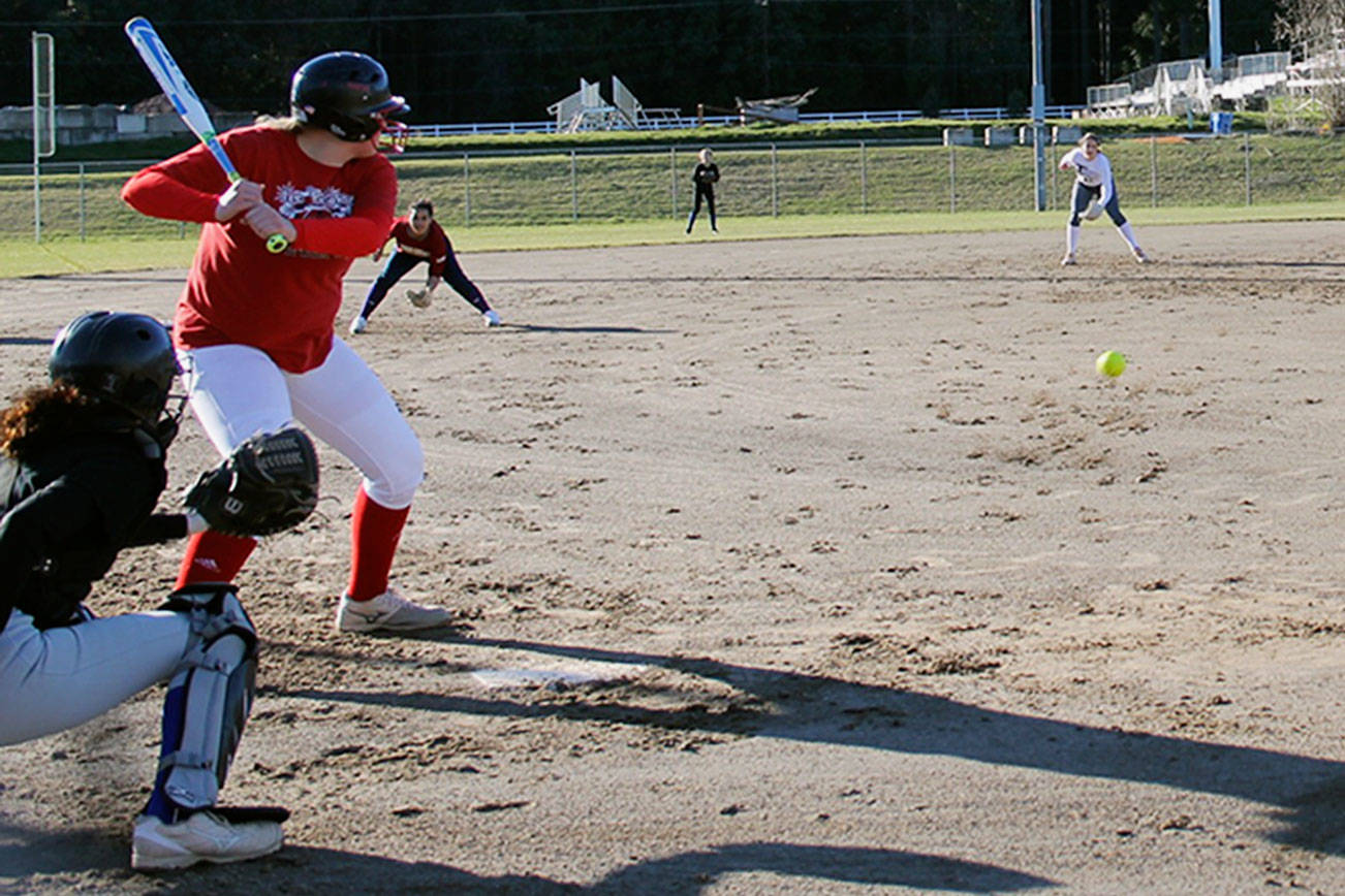 Sophomore Morgan Kroeber in the batter’s box to face senior Dani Snyder, who tosses a pitch during a March 6 practice at Olympic High School. Jacob Moore | Kitsap News Group