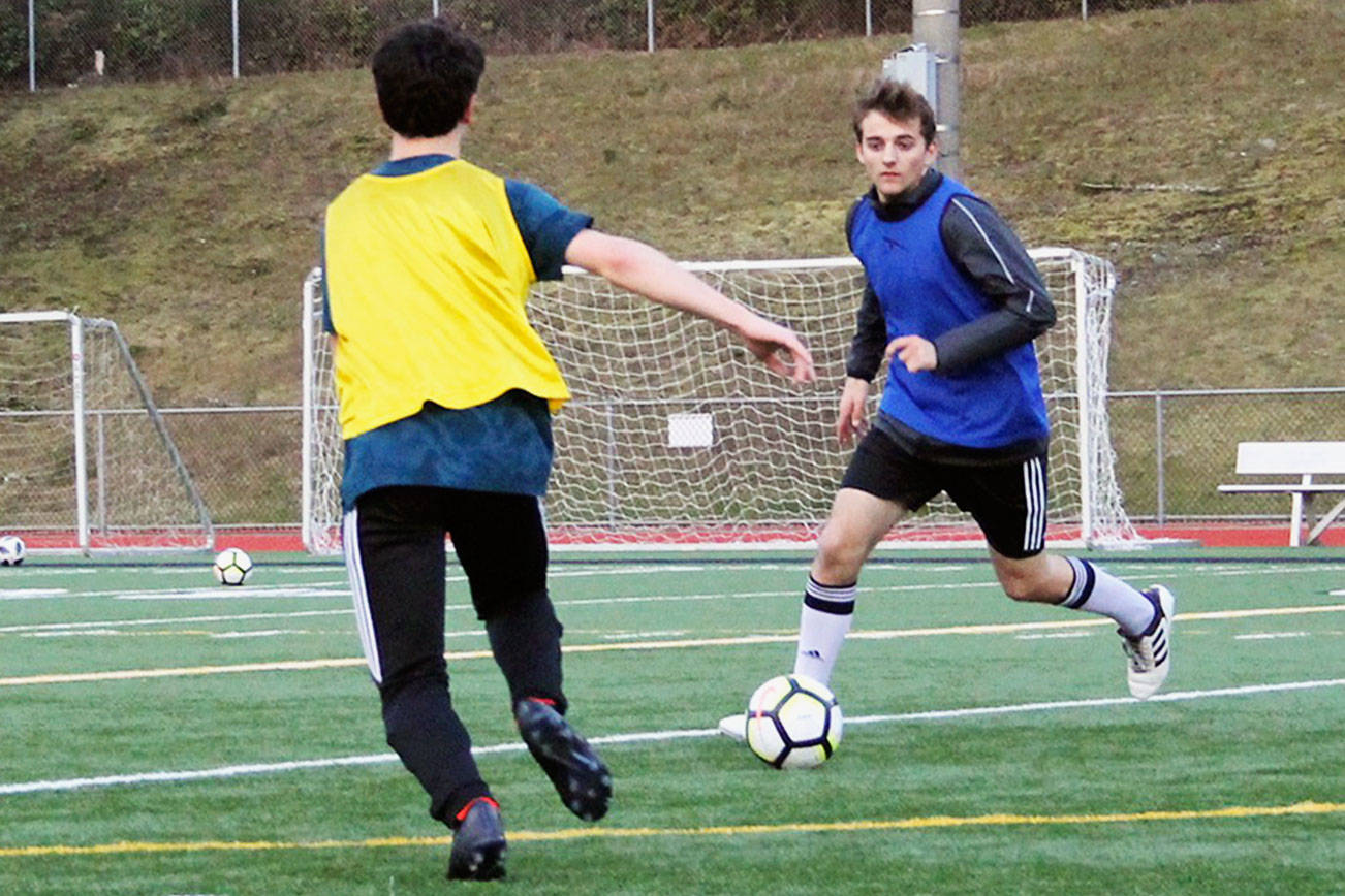 Junior Drew Diefendorf leads the ball in a March 9 practice at Silverdale Stadium.