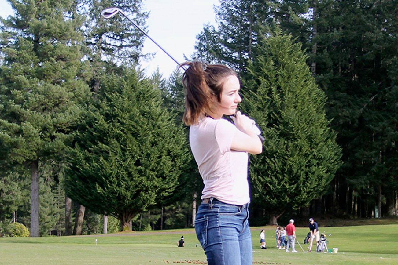 Junior golfer Lucy Holloway practices her swing at Gold Mountain Golf Course during a March 12 practice. (Jacob Moore/Kitsap News Group)