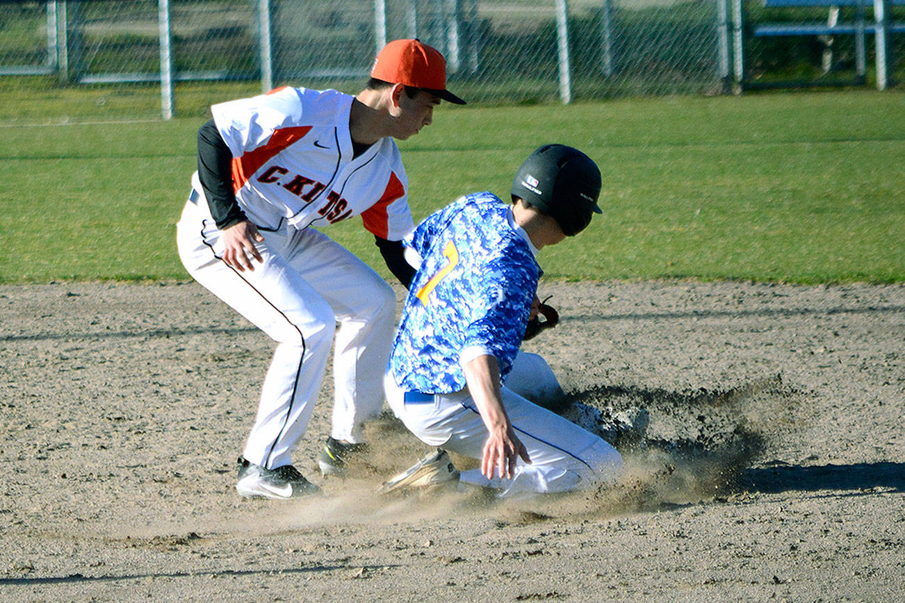 Central Kitsap shortstop Fred Buckson tags out Bainbridge baserunner Theo Colgan. (Mark Krulish/Kitsap News Group)