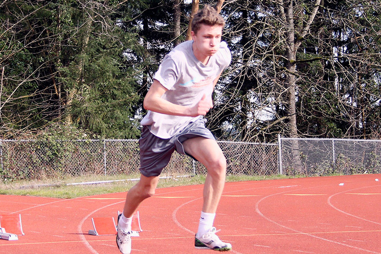 Sophomore high jumper/sprinter Seth Tower practices the start of a sprint at Central Kitsap High School on March 9. (Jacob Moore/Kitsap News Group)