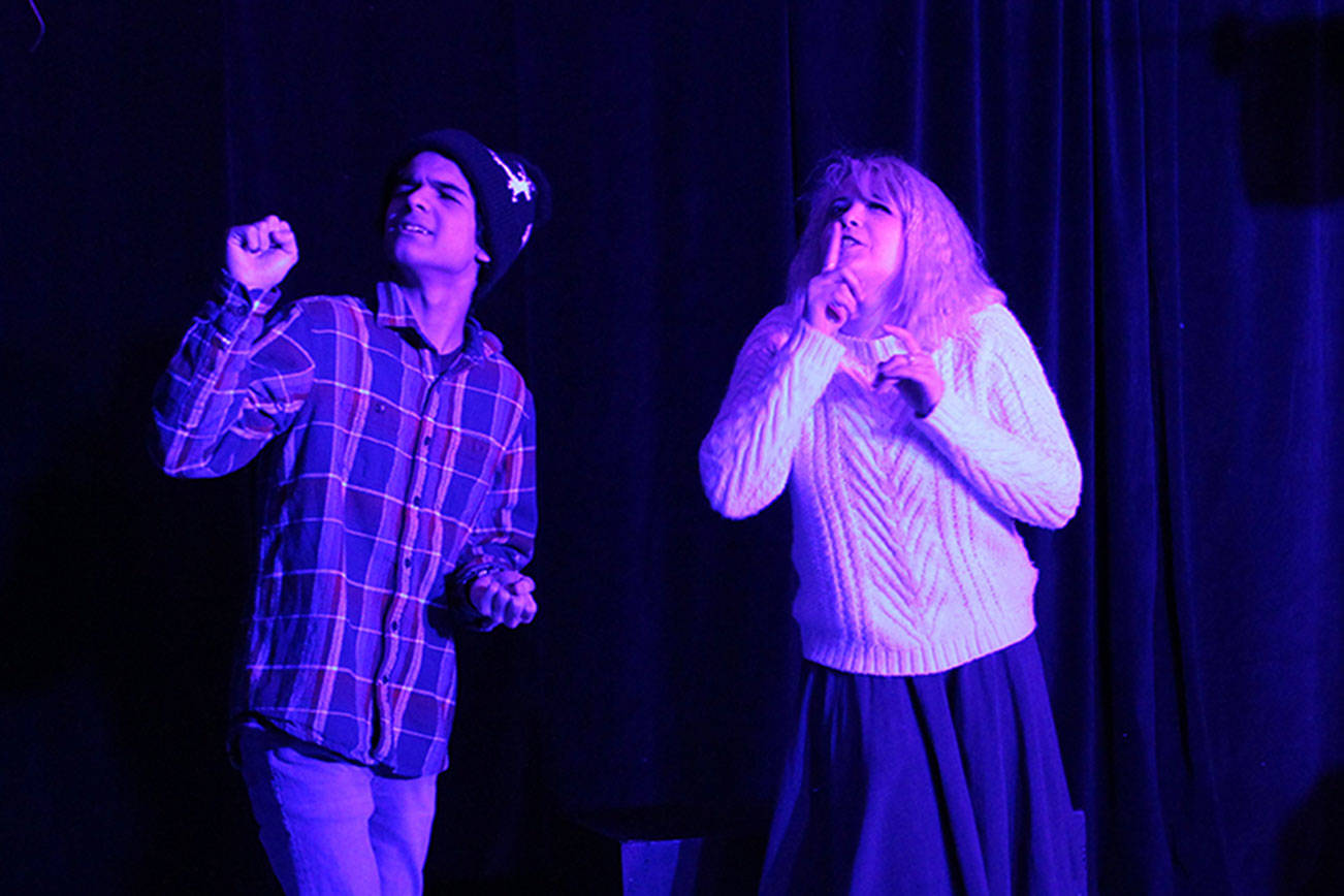 &lt;em&gt;Sophomore cast member Sebastian Flores, left, and senior Sophie Maio, drama club president, sign during a scene of the play, “Almost Maine.”&lt;/em&gt;                                Jacob Moore / Kitsap Daily News