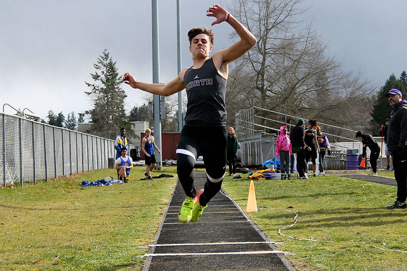 North Kitsap’s Blake Wetzsteon leaps into the air during his triple jump. He wound up taking second place in the event. Jacob Moore | Kitsap News Group
