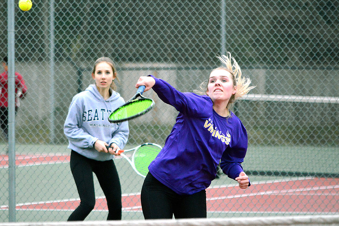 Danya Wallis (foreground) played doubles against Kingston on March 26 with teammate Grace Hansen. Wallis is on a quest to win her fourth singles championship this season. (Mark Krulish/Kitsap News Group)