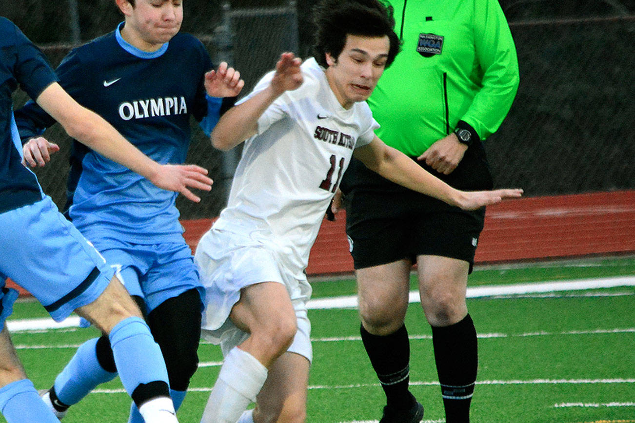 South Kitsap’s Colin Nuss tries to slip past the Olympia midfielders during the March 27 game against the Bears. (Mark Krulish/Kitsap News Group)