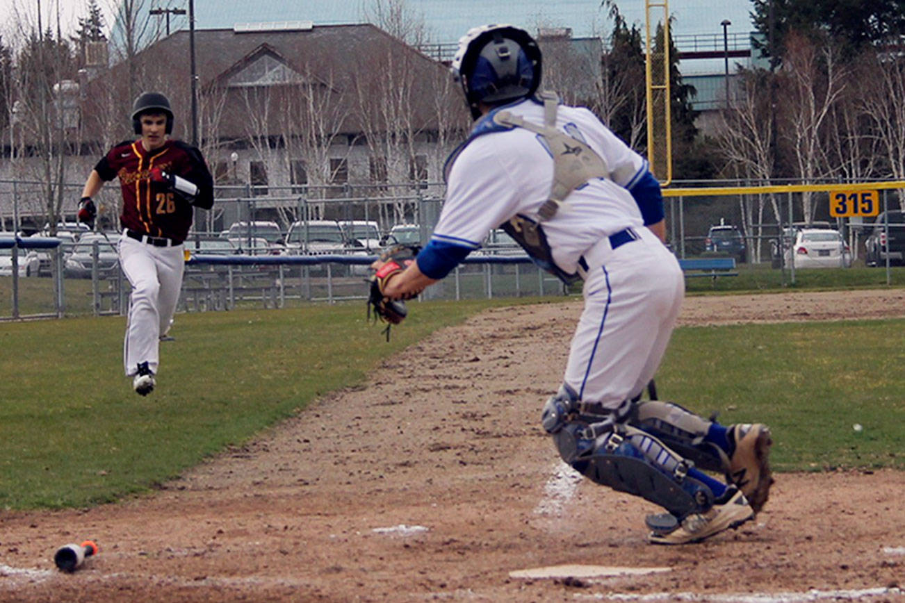 Senior outfielder Gage Updegrove races home to score in the third inning. Kingston won 7-4. Jacob Moore | Kitsap Daily News