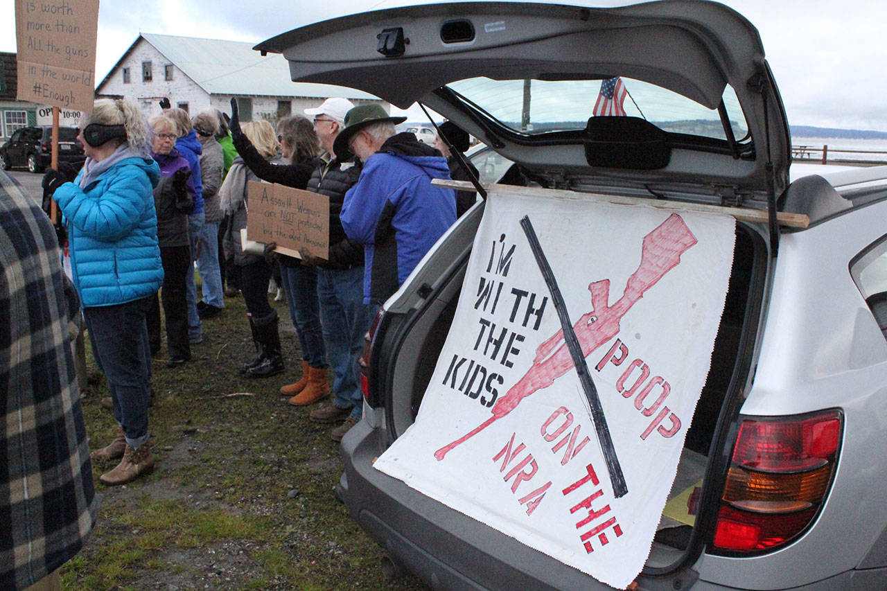 Darroll Gover’s homemade sign is prominently displayed in the back of his car at Norwegian Point Park in Hansville. Nick Twietmeyer | Kitsap News Group