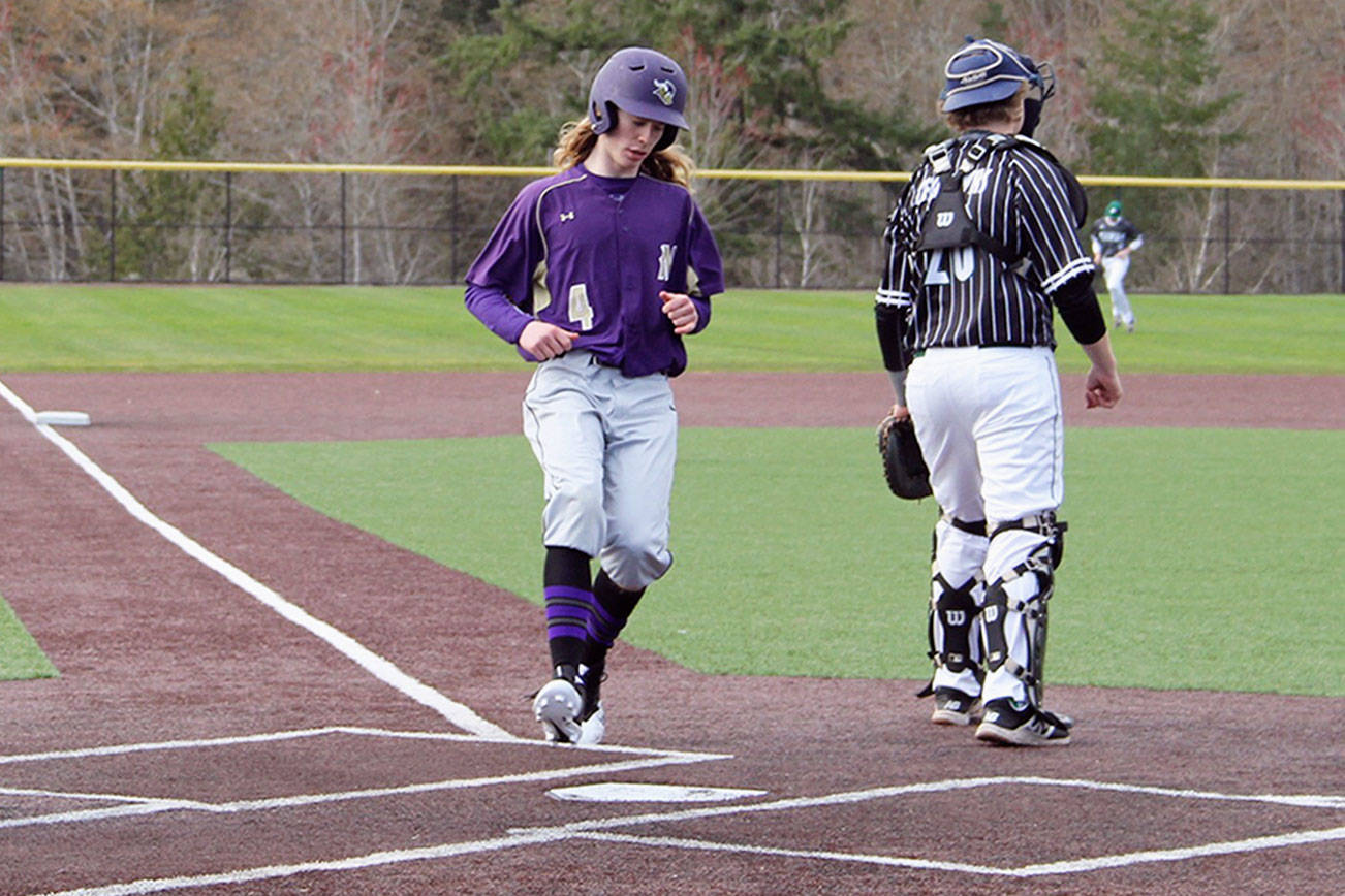 North Kitsap sophomore Nick Alexander attempts to come home on a two-out play in a game against Peninsula on March 30. Jacob Moore | Kitsap Daily News