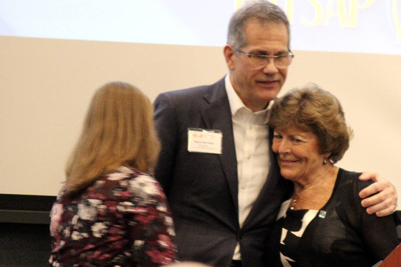 &lt;em&gt;Monica Blackwood, Steve Politakis and Patty Lent hug at the Kitsap Economic Development Alliance meeting March 30 after Blackwood and Politakis granted Lent a lifetime achievement award.&lt;/em&gt; Michelle Beahm / Kitsap News Group