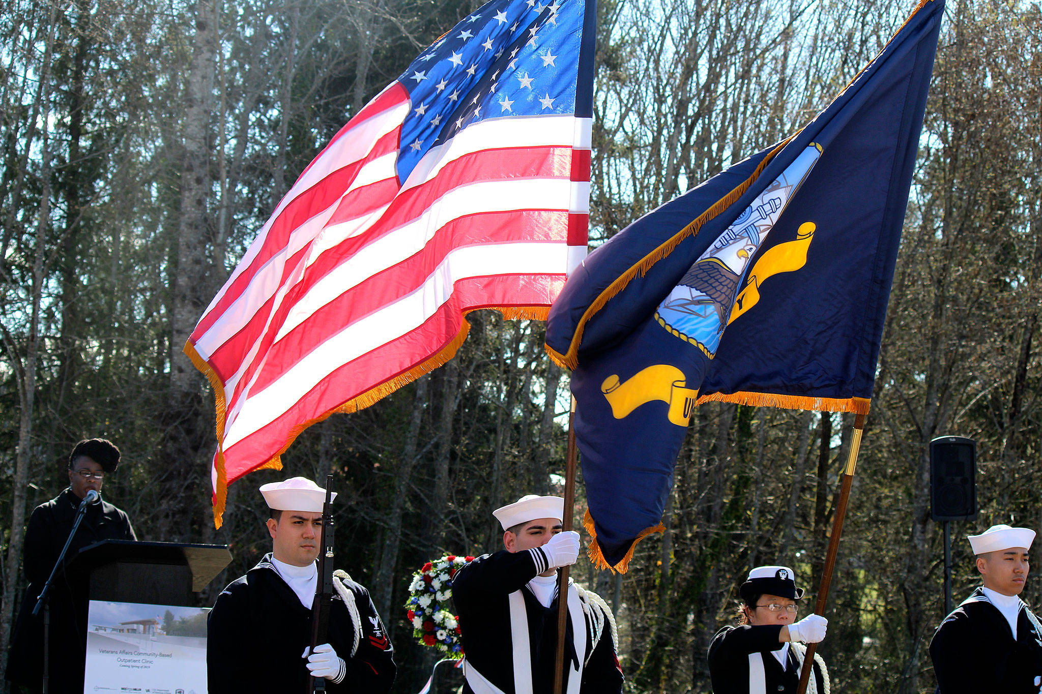 The color guard from the Intermediate Maintenance Facility in Bangor displays the colors while Niki Saulsberry sings the national anthem at the groundbreaking ceremony April 2.                                Michelle Beahm / Kitsap News Group
