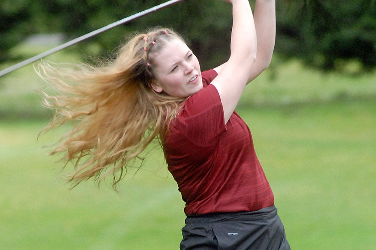 Kingston’s Delaney Olson tees off against Port Angeles High School on the first hole on at Peninsula Golf Course in Port Angeles. Golf has been one of the few sports relatively unaffected by recent rainstorms. (Keith Thorpe/Peninsula Daily News)