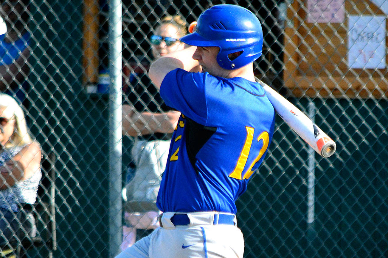 Andy McMartin drives a single into the outfield against Klahowya. (Mark Krulish/Kitsap News Group)