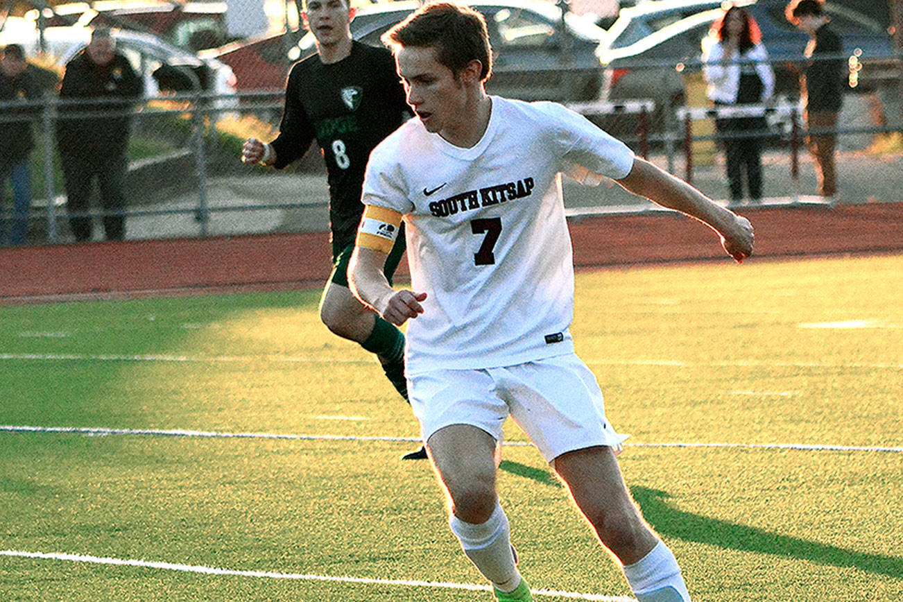 Senior forward Grant Larson dribbles through the Emerald Ridge defense on Senior Night.                                 Mark Krulish |                                 Kitsap News Group