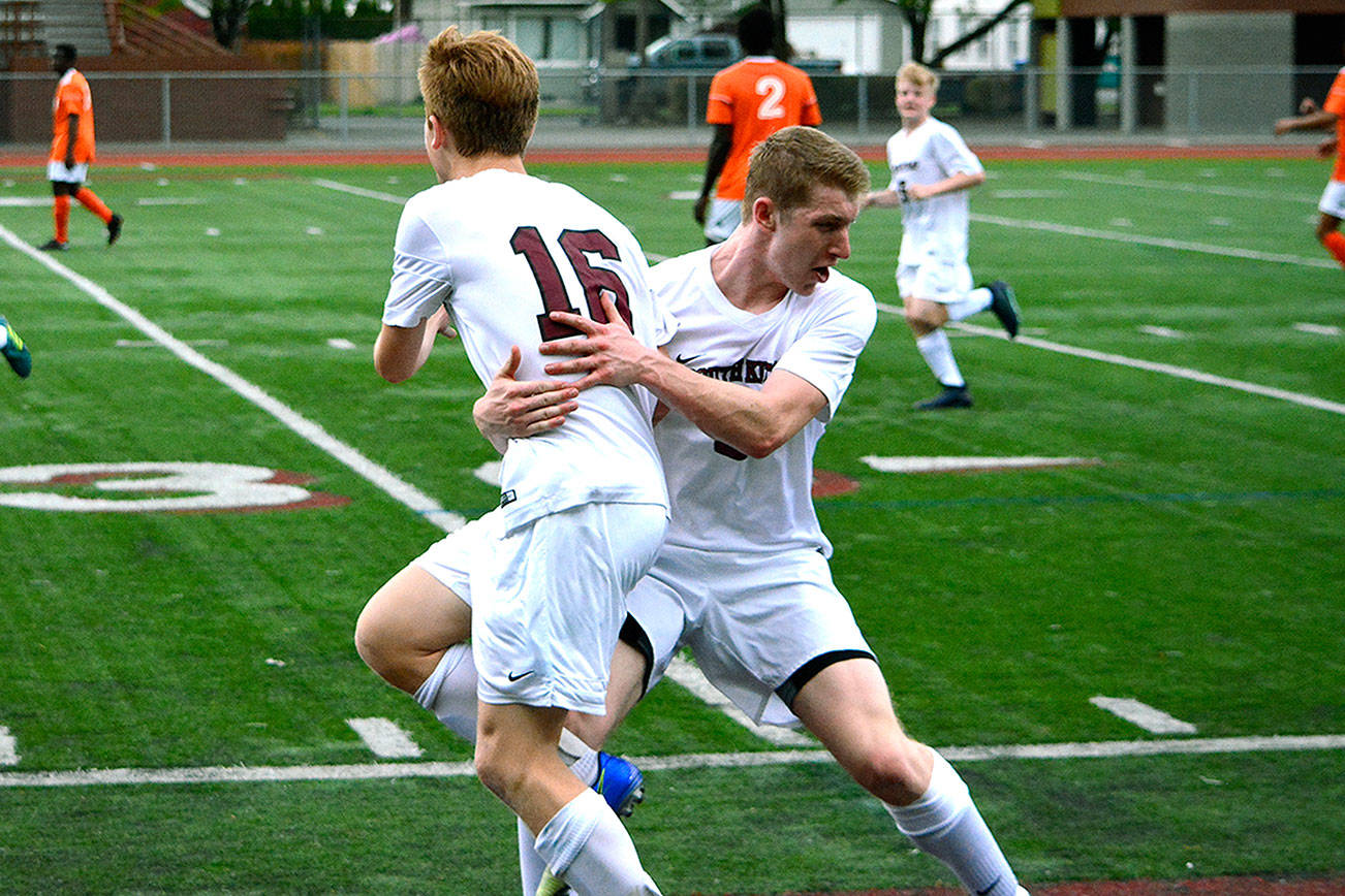 Mark Krulish | Kitsap News Group                                Quinn Dick (2) celebrates with George Robertson (16) after his goal put South Kitsap ahead 2-1. The Wolves advanced to the second round of the district tournament.