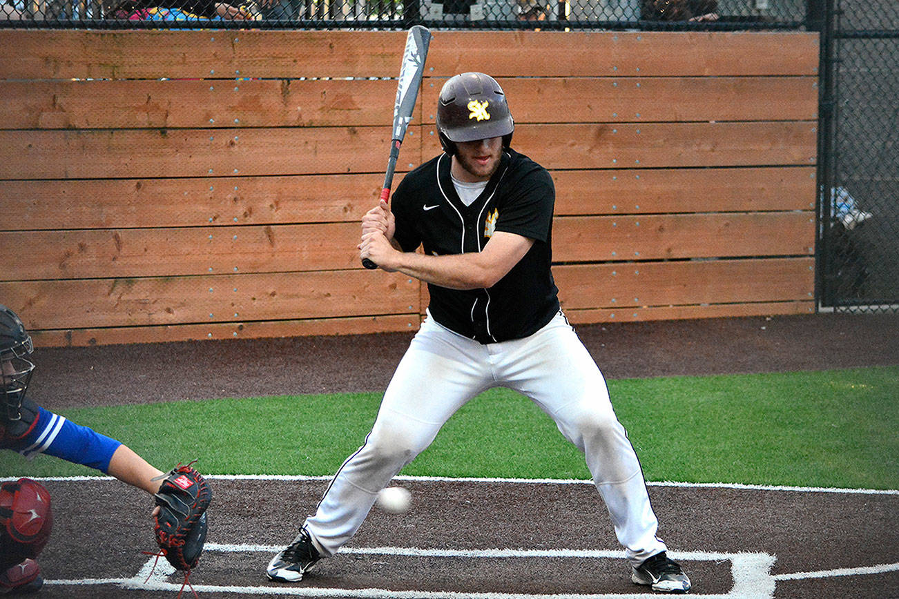 Mark Krulish | Kitsap News Group                                (Left) Jason Sauer got the start on the mound for South Kitsap. (Above) Alex Garcia lets a low pitch go by during the 5-4 district loss to Federal Way. The Wolves now have a longer road to reach the state tournament.