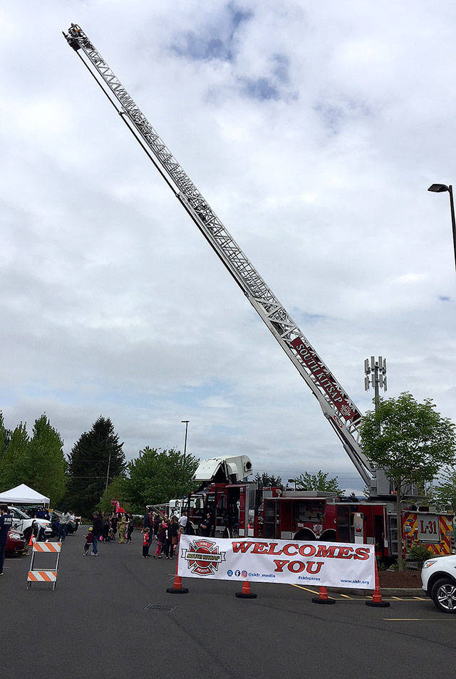 This could qualify as a fold-out photo of the month for a 9-year-old youngster — a South Kitsap Fire and Rescue ladder truck reaching to the sky. Apparatus and equipment from the fire department, as well as from Port Orchard Police, Washington State Patrol and Kitsap County Sheriff’s Office, were on hand to see and touch at the Safety Fair and Bicycle Rodeo May 19 in Port Orchard. (Bob Smith | Kitsap Daily News)
